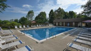 a swimming pool with chairs and a group at Seven Springs 3 Bedroom Standard Townhouse, Sleeps 11! condo in Champion