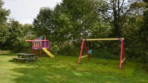 a playground with a picnic table and a swing at Seven Springs 3 Bedroom Standard Townhouse, Sleeps 11! condo in Champion