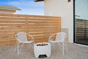 two chairs and a fire pit on a patio at Back Haus - Views, Dark Skies and Fire Pit! home in Joshua Tree