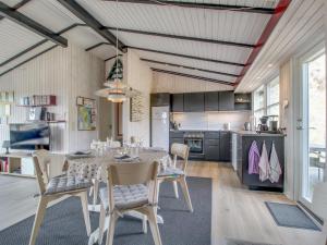 a kitchen and dining room with a table and chairs at Holiday Home Vika - 600m from the sea by Interhome in Fanø