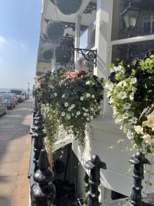 a building with flowers on the side of a street at The Twenty One in Brighton & Hove