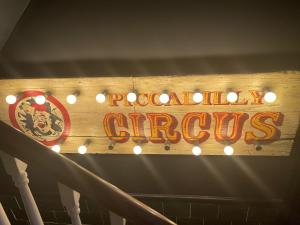 a wooden sign that reads popular circus with lights at The Twenty One B&B in Brighton & Hove +35 photos