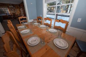 a wooden table with plates and dishes on it at 3664 Birch Avenue cabin in South Lake Tahoe