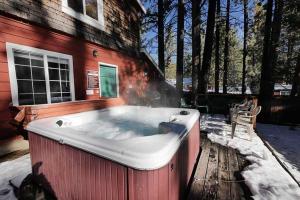 a hot tub sitting outside of a house in the snow at 3664 Birch Avenue cabin in South Lake Tahoe