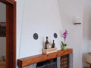 a room with a fireplace with two bottles of wine at Apartment Appartamento da Reto by Interhome in Muralto