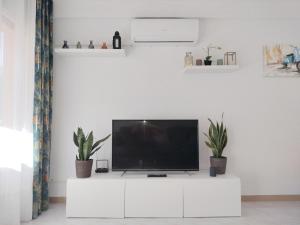 a living room with a tv on a white cabinet at CAMBRILS BEACH APARTMENT in Cambrils