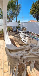 a hammock on the patio of a house at Villa O Canto da Parra - Swimming Pool - WIFI - BY BEDZY in Galé