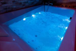 a hot tub with blue lights in it at LOVE ROOM ou pas ! Chamalières in Chamalières