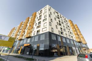 a tall white building on a city street at Superman in Novi Sad