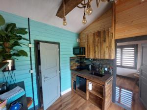 a kitchen with blue walls and a counter top at The Malvern Hills, Courtyard Cabins,Tom Cabin in Great Malvern