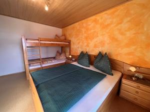 a bedroom with a bed and a bunk bed at Apartment Hinterkerschbaum - BRG105 by Interhome in Taxenbach