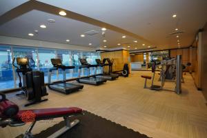 a gym with treadmills and ellipticals in a building at Al Ashrafia Saray - Extraordinary Studio in Canal View in Dubai