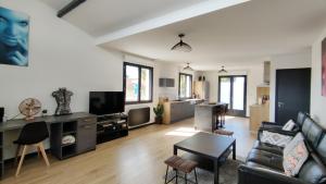 a living room with a couch and a table at Villa Papillon***. Location appartement 1er étage. in Ronce-les-Bains