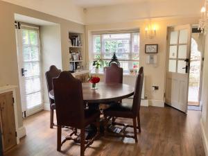 a dining room with a wooden table and chairs at Garden Cottage in Wetherby