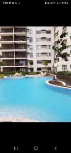 a large swimming pool in front of a building at SERIN WEST TAGAYTAY-Spacious & Comfy 2BR Unit with Parking and Balcony in Tagaytay