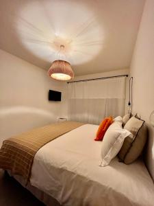 a bedroom with a large white bed with pillows at Senteurs du Maquis in Porticcio