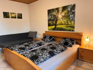 a bedroom with two beds and a painting on the wall at Holiday Home LuxuSölk-3 by Interhome in Stein an der Enns
