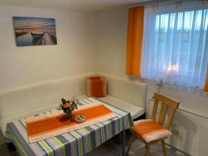 a small table and chair in a small room at Apartment Osterende-1 by Interhome in Süderwisch