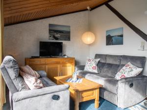 a living room with two couches and a coffee table at Apartment Nordsee-Ferienhaus-3 by Interhome in Friedrichskoog