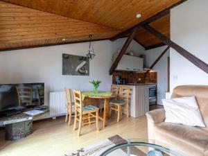 a living room with a table and a couch at Apartment Nordsee-Ferienhaus-4 by Interhome in Friedrichskoog