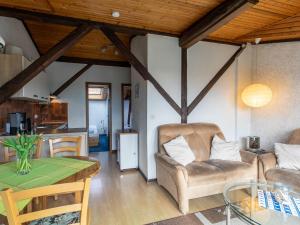 a living room with a couch and a table at Apartment Nordsee-Ferienhaus-4 by Interhome in Friedrichskoog