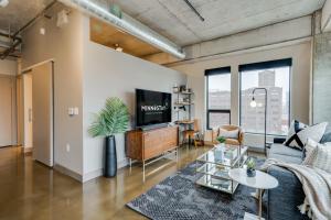 a living room with a couch and a tv at Sable 68 - One Bedroom in Minneapolis