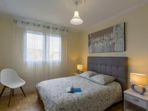 Un dormitorio con una cama con un libro. en Apartment Les Glénans - CCN113 by Interhome, en Concarneau