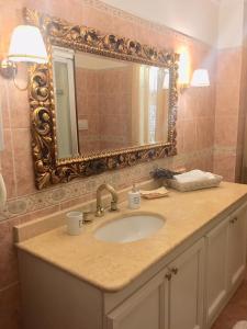 a bathroom with a sink and a mirror at One bedroom house with sea view shared pool and enclosed garden at Montelabbate in Montelabbate