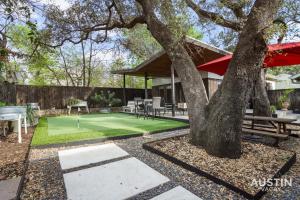 a house with a tennis court in the yard at Entertaining Charmer w Outdoor Games and Putt-Putt in Austin