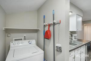 a kitchen with a washing machine and a sink at Everything You Need Near S Lamar Perfect Condo in Austin