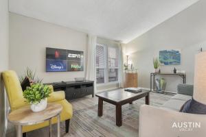 a living room with a couch and a table at Everything You Need Near S Lamar Perfect Condo in Austin