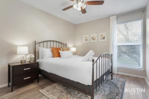 a bedroom with a bed and a ceiling fan at Everything You Need Near S Lamar Perfect Condo in Austin