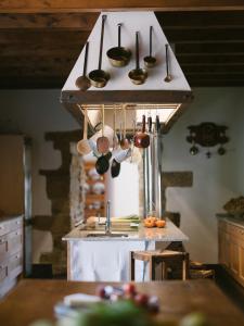 a kitchen with utensils hanging above a sink at Casa Goikomaia in Arrázola