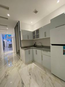 a kitchen with white cabinets and a large floor at شاليهات غزال للفلل الفندقية الفاخرة in Taif