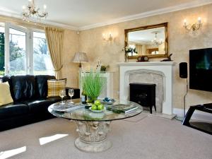 a living room with a table and a fireplace at Bishopsgate in Torquay