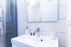 ein Bad mit einem Waschbecken, einem Spiegel und einer Dusche in der Unterkunft SPACIEUX - Proche-gare - Parking in Bourg-en-Bresse