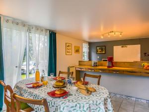 a dining room with a table with food on it at Holiday Home Ty Park - LOQ207 by Interhome in Locquirec