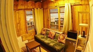 a living room with a couch and two windows at The Spot villa in Dahab