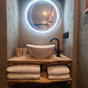 a bathroom with a bowl sink and a mirror at Feel at Home - Holiday Studio in Gulpen +25 photos