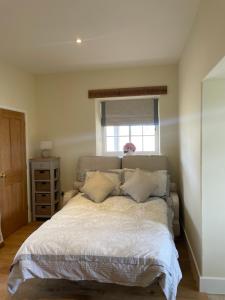 a bedroom with a large bed with a window at The Cobbles in Towcester
