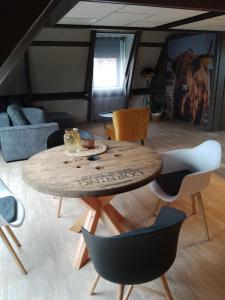 a living room with a wooden table and chairs at Vakantieverhuur Noordwolde in Noordwolde