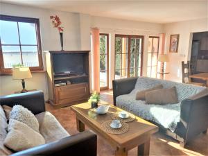 a living room with a couch and a table at Vila Lipno in Frymburk