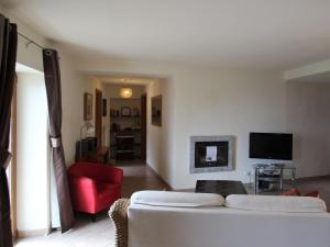 a living room with a white couch and a red chair at Holiday Home Monte Tabor by Interhome in Carmine