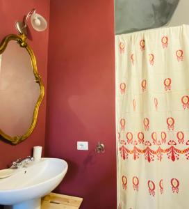 a bathroom with a sink and a shower curtain at L' estate di san Martino Room Rental - free park in Asti