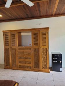 a large wooden cabinet with a television in a room at Kayu Surf Resort in La Libertad