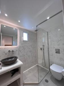 a bathroom with a shower and a sink and a toilet at Mykonos Eight in Mýkonos City