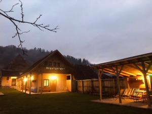 a house with lights in the yard at night at Casa Eva Wagner - Biertan in Biertan