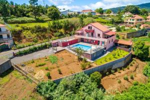 an aerial view of a house with a swimming pool at 2 bedrooms apartement with shared pool enclosed garden and wifi at Prazeres 5 km away from the beach in Campanário