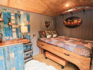 a bedroom with a bed and a desk in it at The Hideaway, Shepherd's Hut in Scarborough