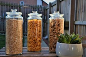 trois bocaux en verre remplis de différents types de semences dans l'établissement Peaceful, Lovely and Modern, Entire House, à Édimbourg
